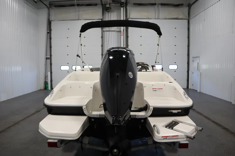 Slide: The Image of 2021 Bayliner 16 Element boat in a garage, rear view with outboard motor. - 6