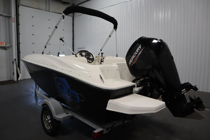 Slide: The Image of 2021 Bayliner 16 Element boat with Mercury outboard motor in a garage setting. - 7