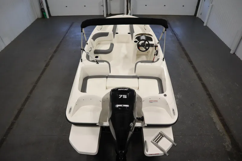 Slide: The Image of 2021 Bayliner 16 Element boat with Mercury 75 engine in a garage setting. - 10