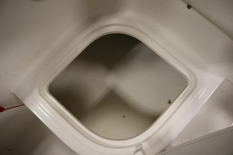 Slide: The Image of Storage compartment of 2021 Bayliner 16 Element boat, featuring a clean, white interior. - 23