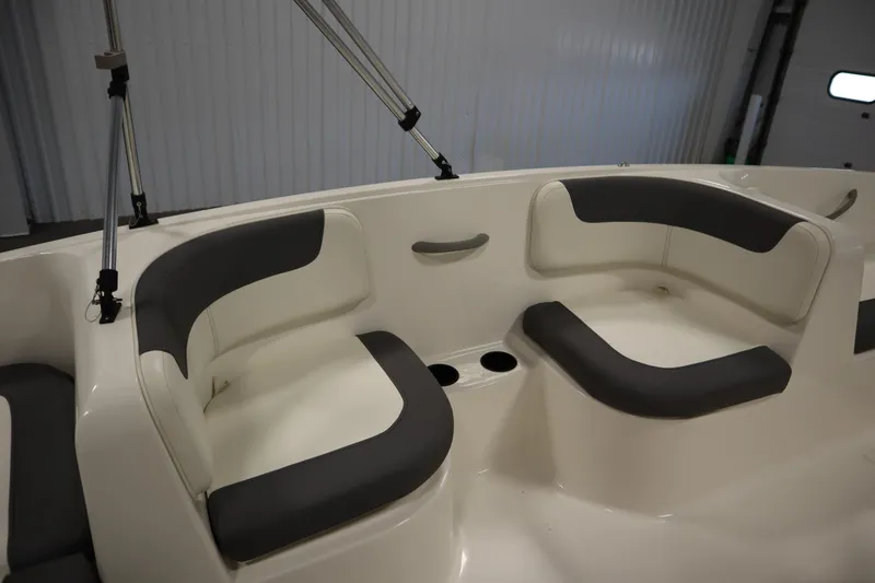 Slide: The Image of 2021 Bayliner 16 Element boat interior with cushioned seating and cup holders. - 24