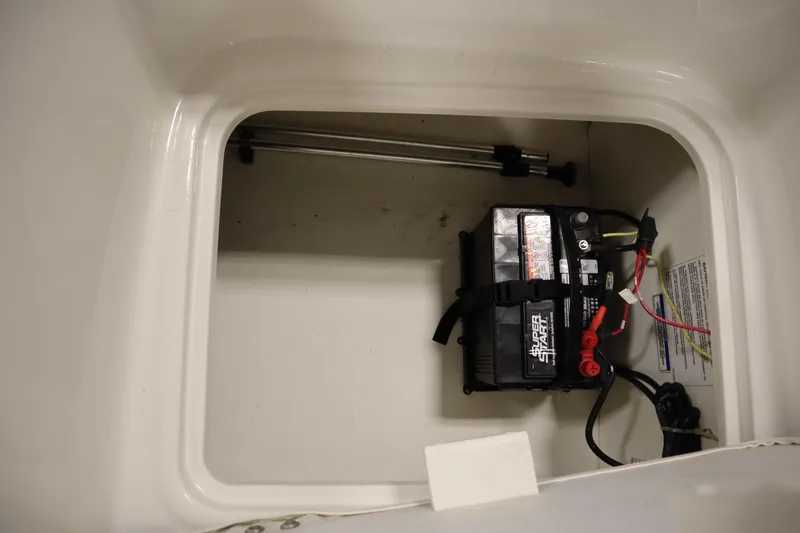 Slide: The Image of 2021 Bayliner 16 Element boat battery compartment with secured battery and wiring. - 29