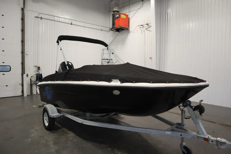 Slide: The Image of 2021 Bayliner 16 Element boat with cover on trailer in indoor storage. - 38