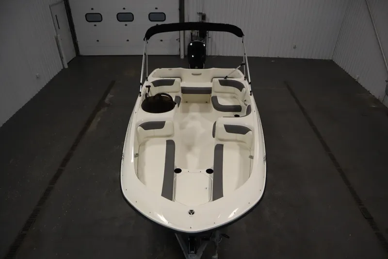 Slide: The Image of 2021 Bayliner 16 Element boat in a garage, featuring spacious seating and sleek design. - 9