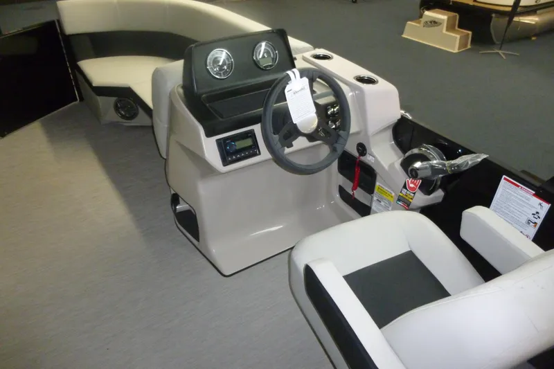 Slide: The Image of Interior of 2025 Harris Breese 210 boat with modern steering console and seating. - 4