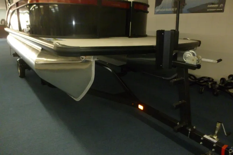 Slide: The Image of 2025 Harris Breese 210 pontoon boat on trailer, indoor showroom display. - 7