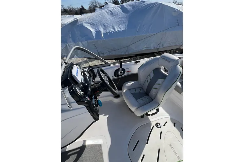 Slide: The Image of 2020 Nitro Z19 Sport boat interior with steering wheel and cushioned seat. - 11