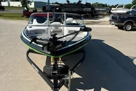 Slide: The Image of 2020 Nitro Z19 Sport boat with outboard motor, parked on gravel near a building. - 4