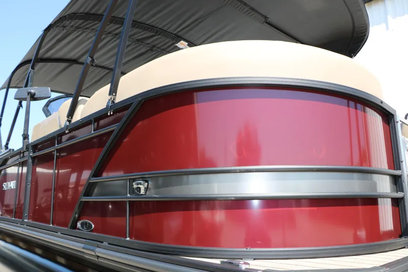 Slide: The Image of 2025 Sylvan L3 DLZ pontoon boat with red exterior and beige seating. - 14