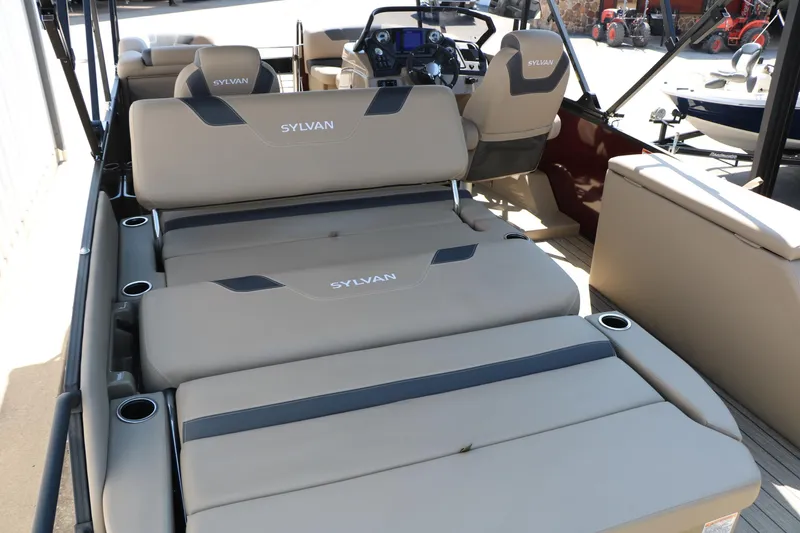 Slide: The Image of 2025 Sylvan L3 DLZ pontoon boat interior with beige seating and modern dashboard. - 19