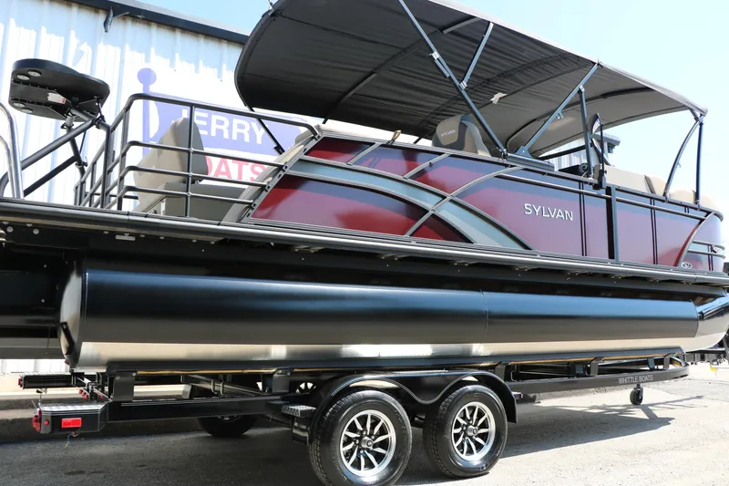 Slide: The Image of 2025 Sylvan L3 DLZ pontoon boat with canopy on trailer, side view. - 2