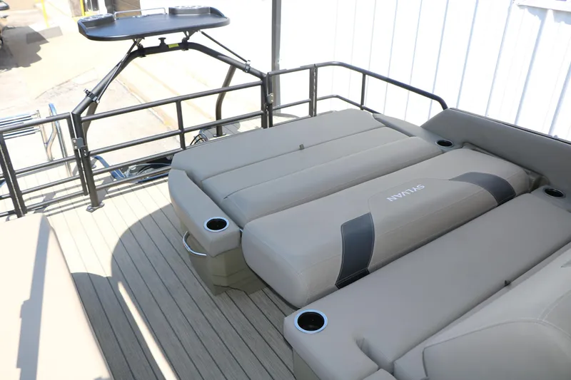 Slide: The Image of 2025 Sylvan L3 DLZ pontoon boat with beige seating and cup holders. - 22