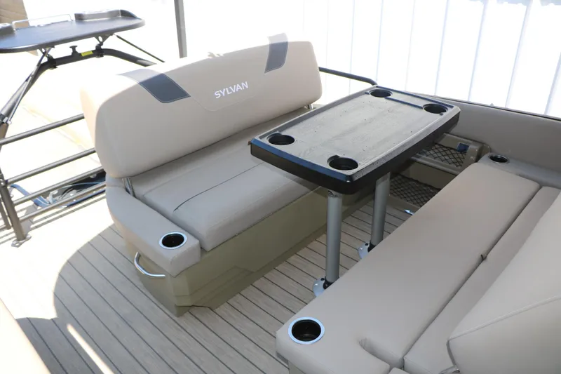 Slide: The Image of Interior of 2025 Sylvan L3 DLZ pontoon boat with beige seating and table. - 26