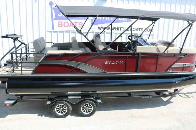 Slide: The Image of 2025 Sylvan L3 DLZ pontoon boat with canopy, red and black design, on trailer. - 3