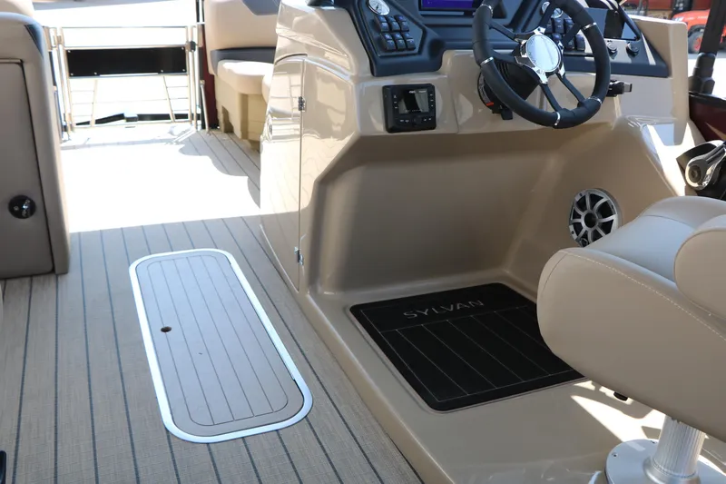 Slide: The Image of 2025 Sylvan L3 DLZ boat interior with steering wheel and beige seating. - 30