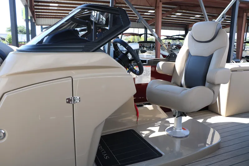 Slide: The Image of 2025 Sylvan L3 DLZ boat interior with captain's chair and steering console. - 34