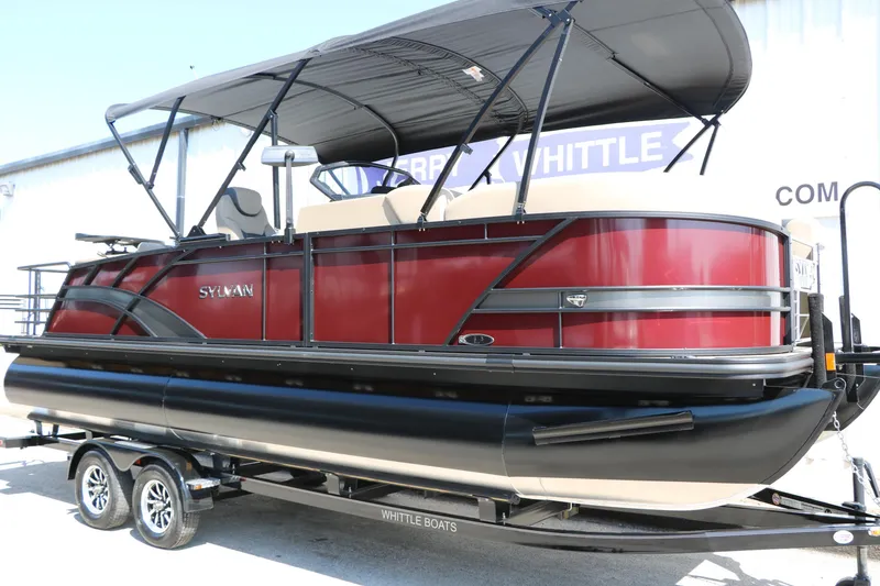 Slide: The Image of 2025 Sylvan L3 DLZ pontoon boat with canopy on trailer, red and black design. - 5