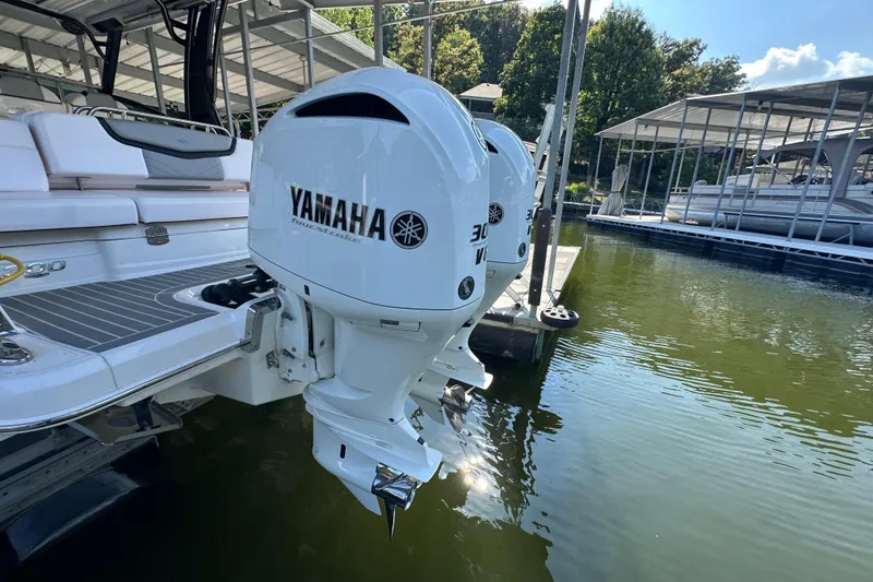Slide: The Image of 2020 Chaparral 300 OSX with Yamaha outboard engines docked at marina. - 11