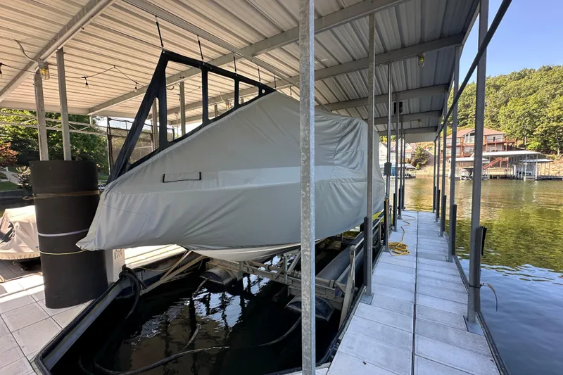 Slide: The Image of Covered 2020 Chaparral 300 OSX boat docked in a sheltered marina. - 19