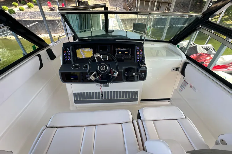 Slide: The Image of 2020 Chaparral 300 OSX boat cockpit with modern controls and navigation system. - 22