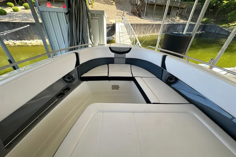 Slide: The Image of 2020 Chaparral 300 OSX boat interior with cushioned seating and cup holders. - 30