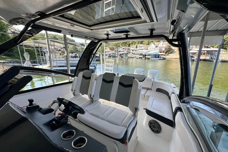 Slide: The Image of 2020 Chaparral 300 OSX boat interior with sleek seating and waterfront view. - 34