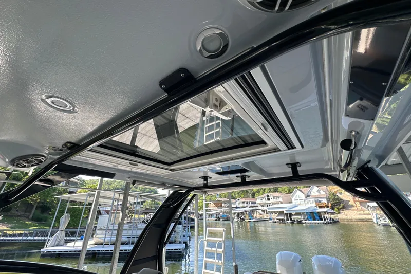 Slide: The Image of 2020 Chaparral 300 OSX boat interior with sunroof and waterfront view. - 35