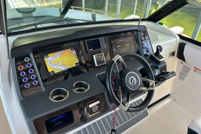 Slide: The Image of Helm of 2020 Chaparral 300 OSX boat with navigation screens and controls. - 36