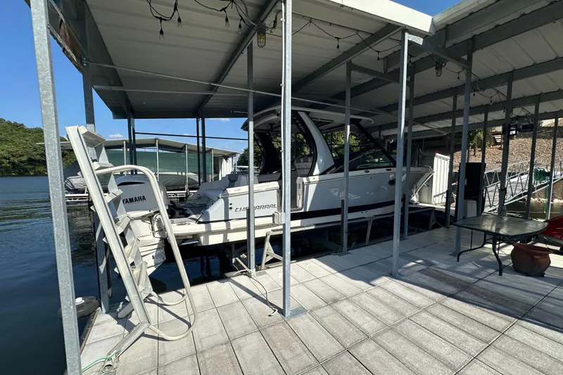 Slide: The Image of 2020 Chaparral 300 OSX boat docked under covered marina with Yamaha engine. - 4