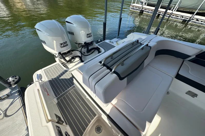 Slide: The Image of 2020 Chaparral 300 OSX boat with twin Yamaha 300 engines, docked on calm water. - 47