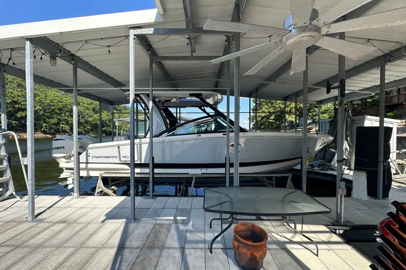 Slide: The Image of 2020 Chaparral 300 OSX boat docked under covered marina with Yamaha engine. - 5