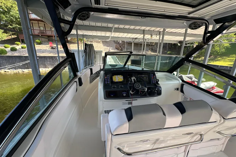 Slide: The Image of Interior view of 2020 Chaparral 300 OSX boat cockpit with modern controls and seating. - 51