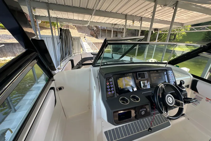 Slide: The Image of 2020 Chaparral 300 OSX boat interior with modern dashboard and steering wheel. - 53