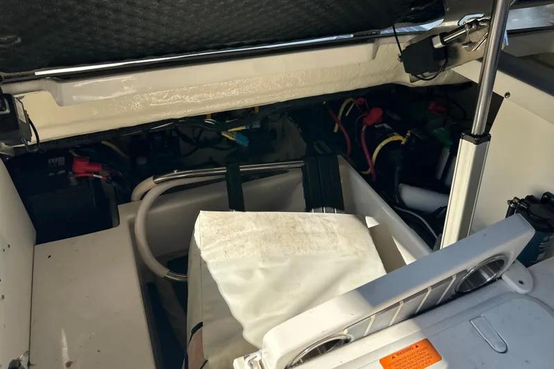 Slide: The Image of 2020 Chaparral 300 OSX boat interior showing engine compartment and wiring. - 55