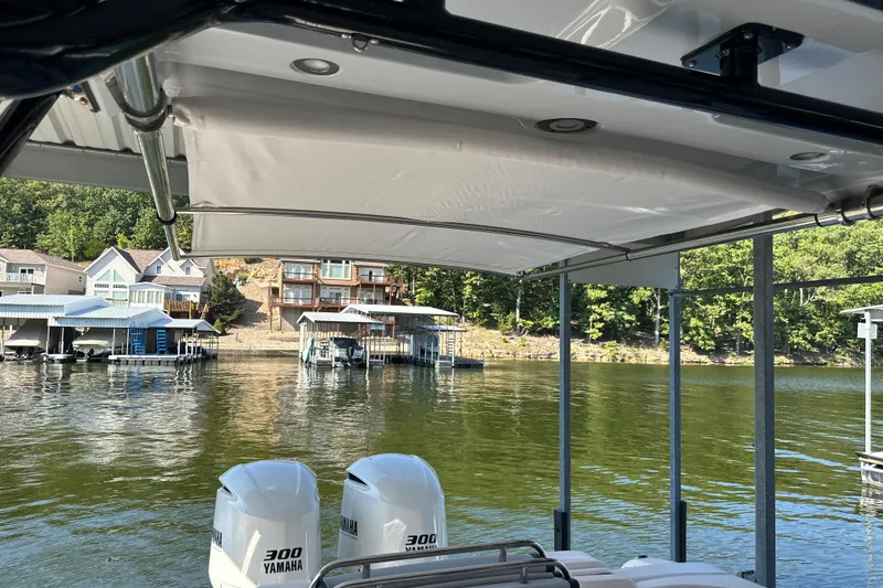 Slide: The Image of 2020 Chaparral 300 OSX boat with Yamaha engines docked on a scenic lake. - 59