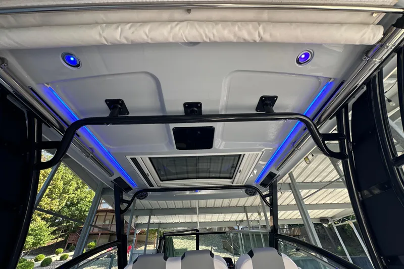 Slide: The Image of 2020 Chaparral 300 OSX boat interior with blue LED lighting and modern design. - 65