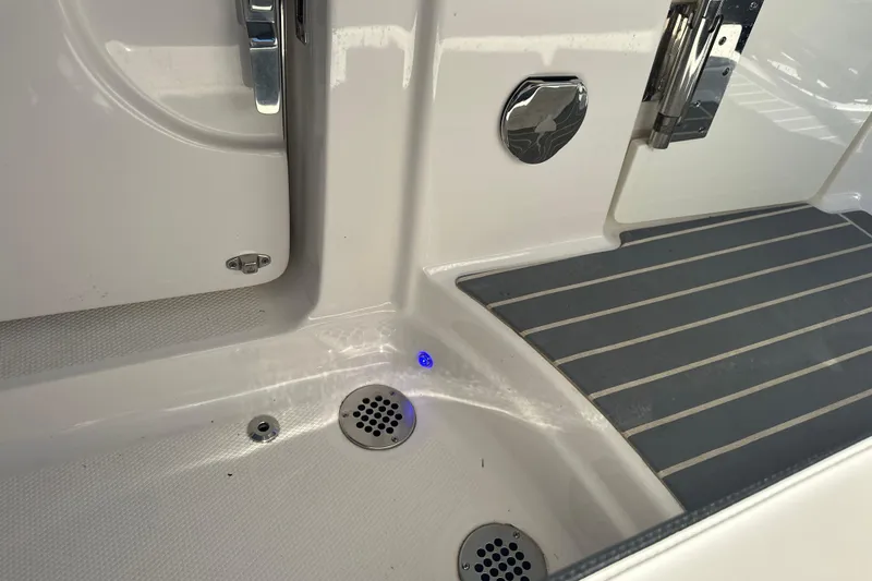 Slide: The Image of 2020 Chaparral 300 OSX boat interior with drain and non-slip flooring. - 67