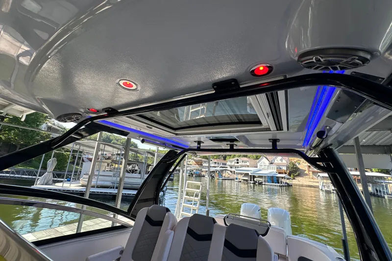 Slide: The Image of 2020 Chaparral 300 OSX boat interior with LED lighting and waterfront view. - 68