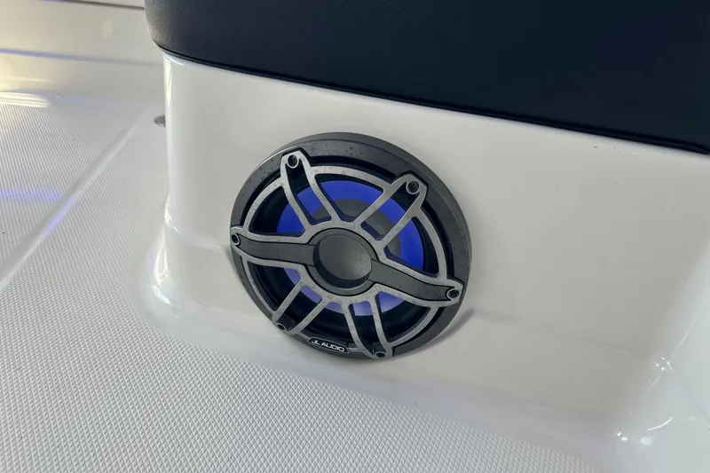 Slide: The Image of Speaker on 2020 Chaparral 300 OSX boat, featuring JL Audio with blue lighting. - 69