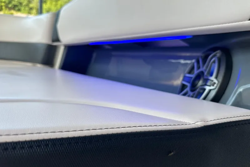 Slide: The Image of 2020 Chaparral 300 OSX boat interior with speaker and blue LED lighting. - 70