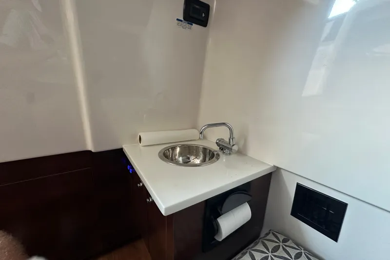 Slide: The Image of 2020 Chaparral 300 OSX boat interior with compact sink and countertop. - 79