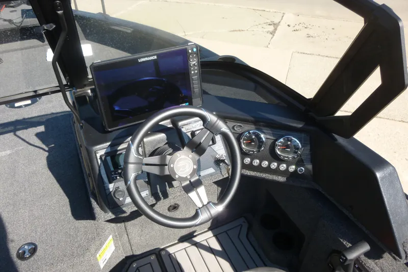 Slide: The Image of 2026 Crestliner 2050 Fish Hawk dashboard with steering wheel and navigation display. - 3