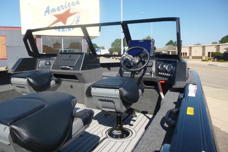 Slide: The Image of 2026 Crestliner 2050 Fish Hawk boat interior with steering wheel and seating. - 5