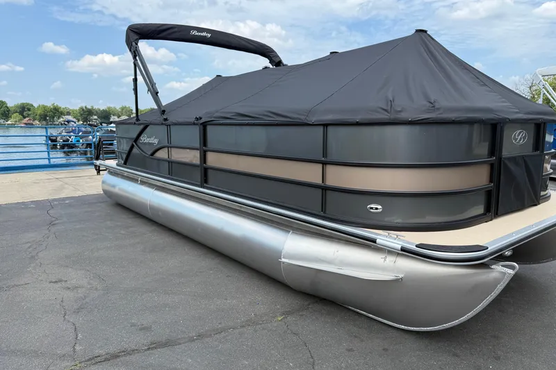 Slide: The Image of 2026 Bentley Pontoons Fish 220 Fish-N-Cruise pontoon boat docked, covered with black canopy. - 4