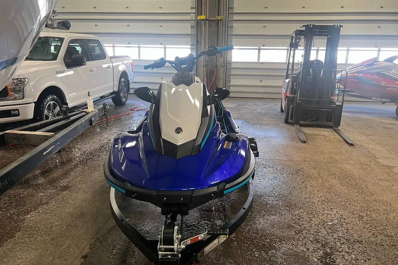 Slide: The Image of 2024 Yamaha JETBLASTER in a garage, surrounded by vehicles and equipment. - 2