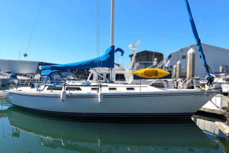 The Image of Catalina 42 sailboat from 1990 docked near colorful waterfront houses. - 0