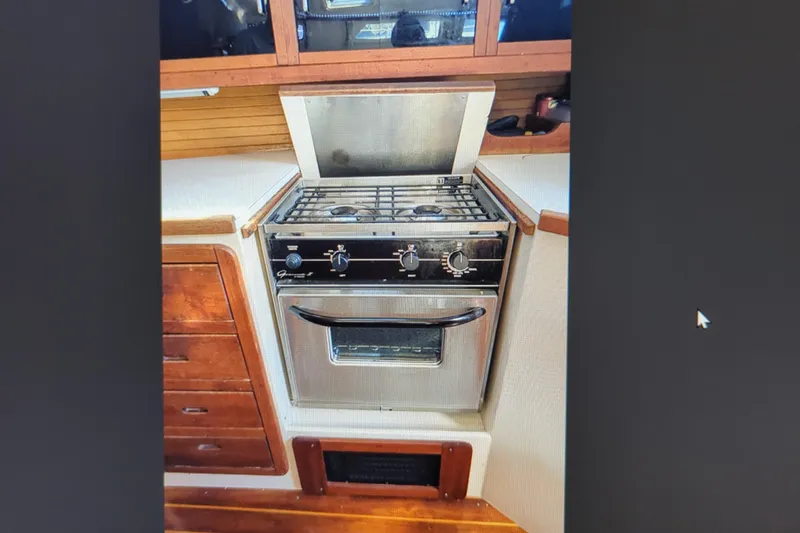 Slide: The Image of Stainless steel stove in 1990 Catalina 42 yacht kitchen with wooden cabinetry. - 18