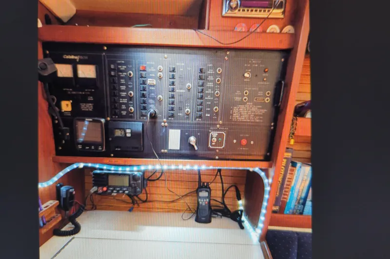 Slide: The Image of Control panel of a 1990 Catalina 42 sailboat with navigation and communication equipment. - 19