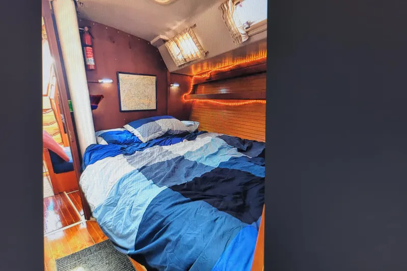 Slide: The Image of Interior of 1990 Catalina 42 sailboat with wooden cabinetry and colorful towels. - 23