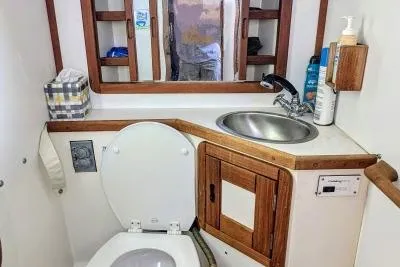 Slide: The Image of Blue-covered equipment on a 1990 Catalina 42 sailboat docked at a marina. - 29